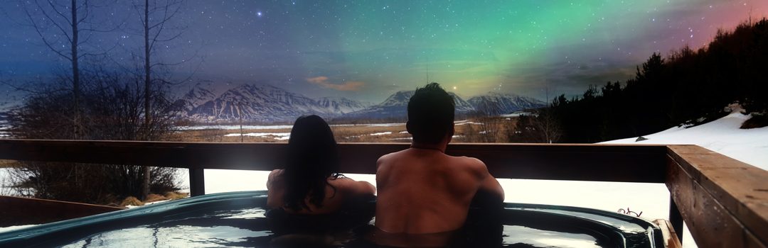 couple observing northern lights iceland